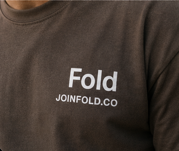 Close-up of the white "Fold / JOINFOLD.CO" wordmark printed on the chest